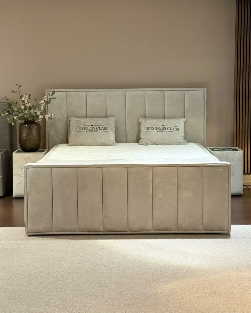 Luxe bed met beige hoofdbord en sierkussens